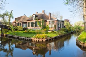 Beautiful traditional house with a thatched roof on a small island in a Dutch town of Giethoorn