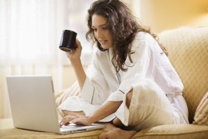 Woman working at home with laptop computer